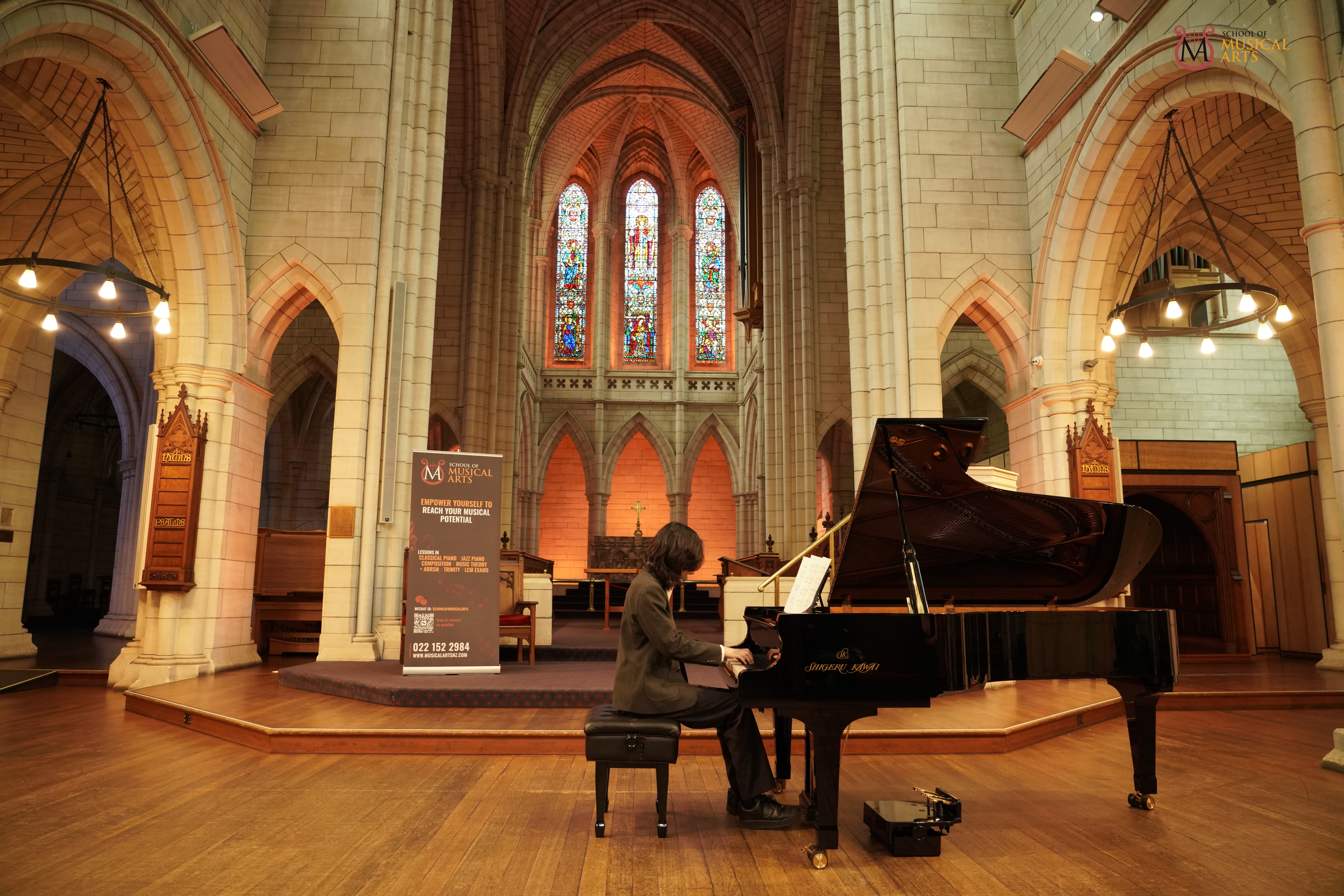 Pianist performing a recital on stage for a diploma examination