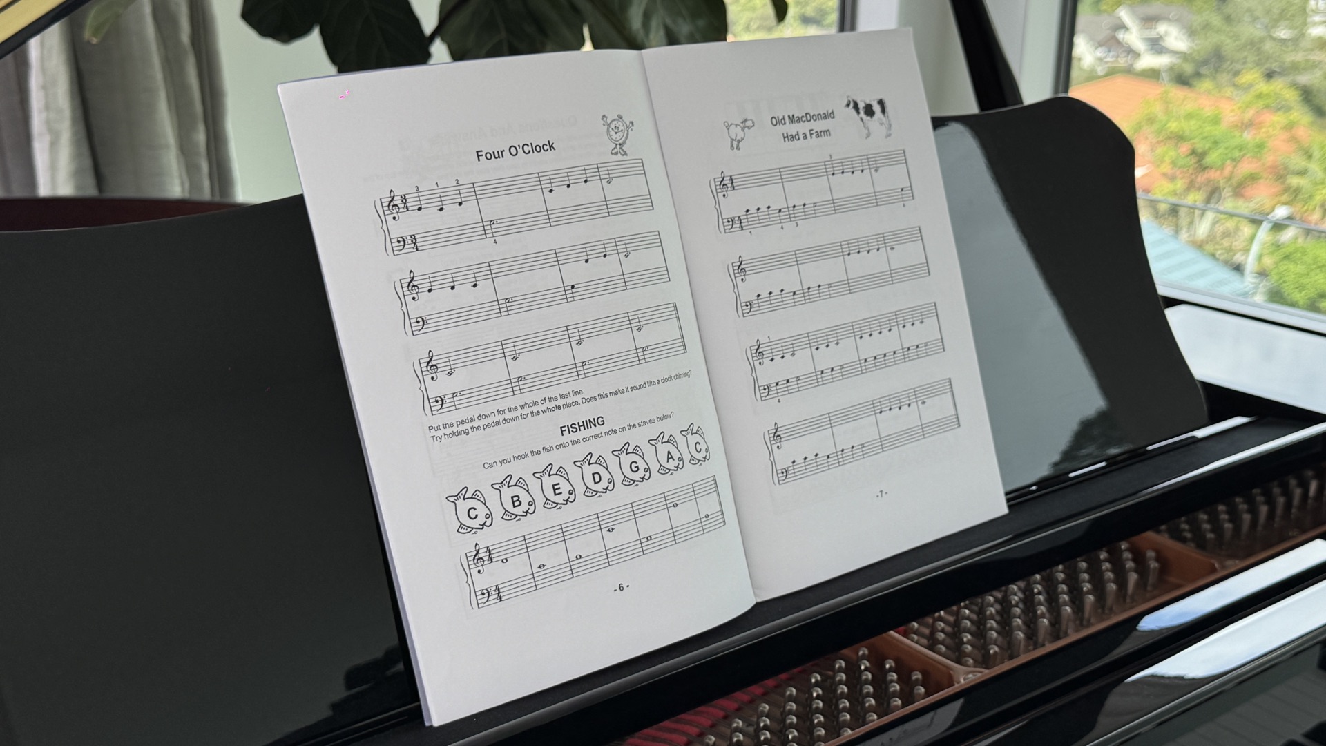 Young child learning piano sight reading with sheet music