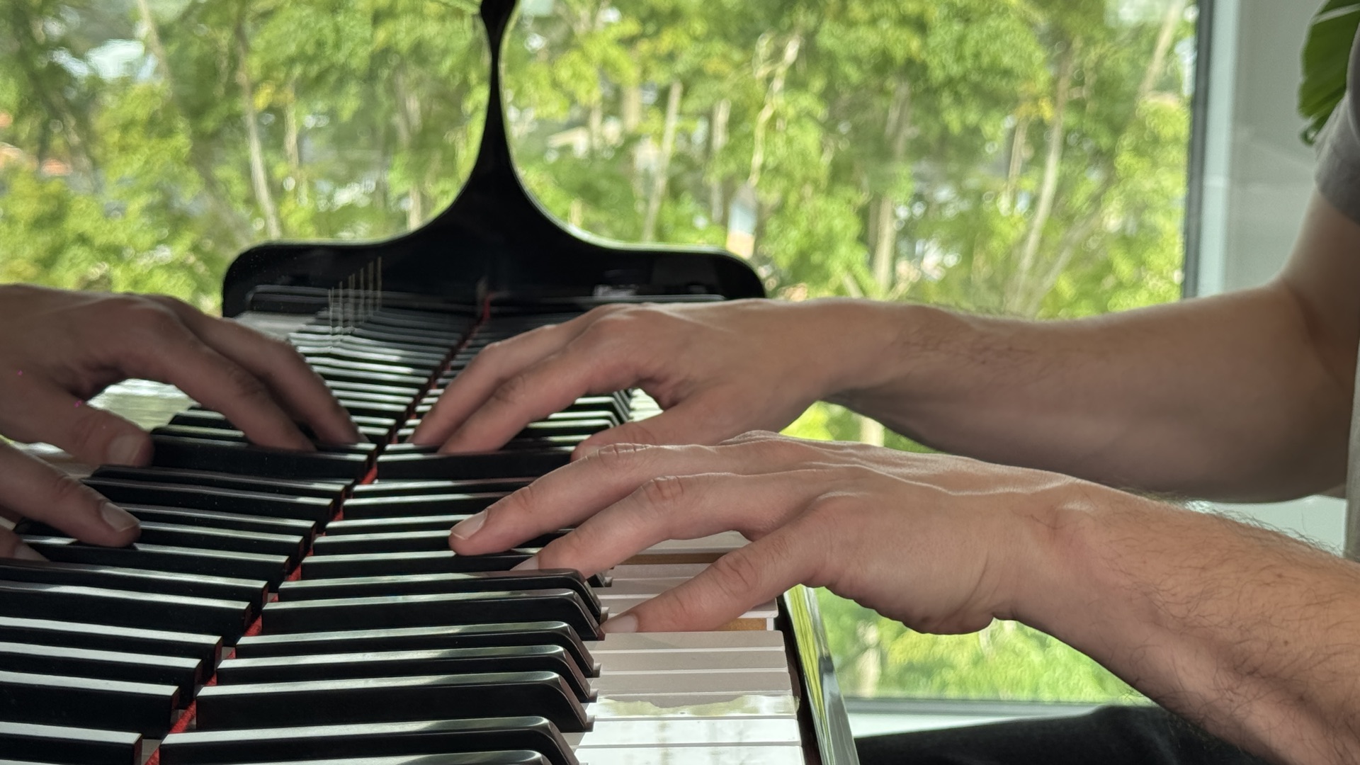 Beginner learning piano at the keyboard during a first lesson