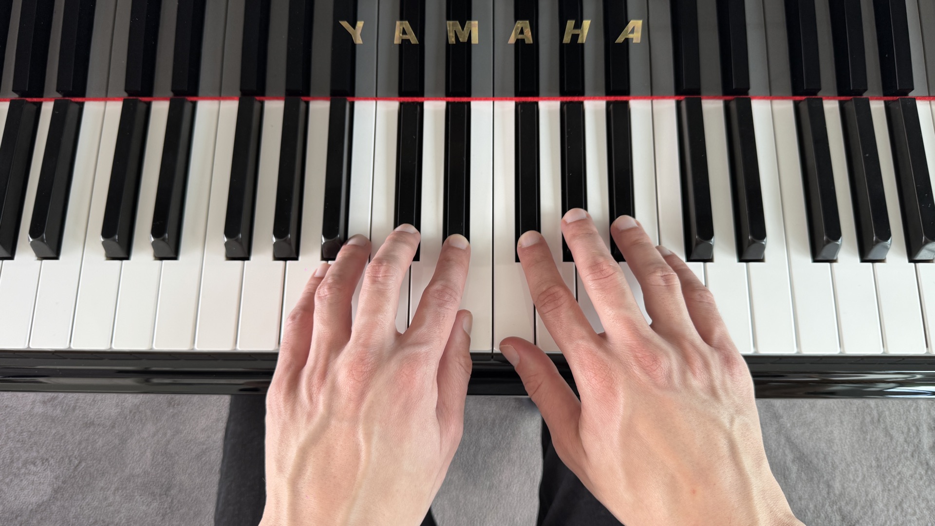 Close-up of piano keyboard showing groups of two and three black keys
